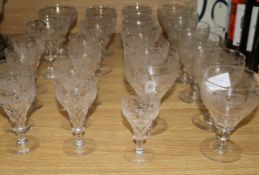 A suite of vine etched cut glass wine and other glasses