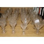 A suite of vine etched cut glass wine and other glasses