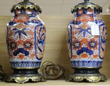 A pair of Victorian brass mounted Imari table lamps, with later fittings, 15in.
