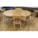 A pine extending dining table and four chairs, W.159cm fully extended with 1 leaf