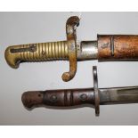A French Yataghan bayonet and scabbard and a US WWI bayonet and scabbard dated 1917 by Remington