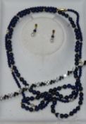 A lapis lazuli bead necklace and a silver and paste bracelet.