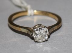 An 18ct gold and platinum solitaire diamond ring, size N.