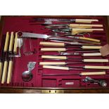 A part canteen of plated cutlery and other plated flatware housed in an oak canteen with brass