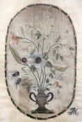 A late 18th / early 19th century silkwork panel, depicting flowers in an urn, monogrammed TM, 16 x