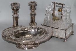 A pair of plated telescopic candlesticks, a cruet stand and a basket