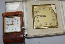 A Swiss gilt-metal travelling alarm clock in Asprey folding leather case and another smaller leather