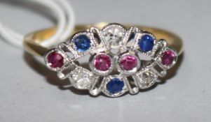A 15ct gold, ruby, sapphire and diamond set elliptical shaped ring, size Q.