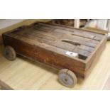 An Edwardian pine trolley housing a set of 20th century oak building blocks, 22.5in.