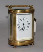 A late 19th century French brass oval cased eight day carriage timepiece