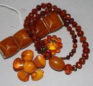 An amber bracelet, two amber brooches and an amber necklace.