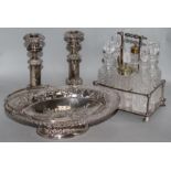 A pair of plated telescopic candlesticks, a cruet stand and a basket