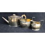 A Georgian matched three-piece silver teaset, oval-bodied with moulded edges, the teapot London