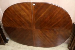 An extending mahogany dining table, W.150cm