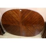 An extending mahogany dining table, W.150cm