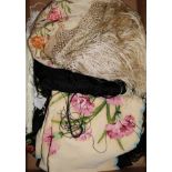 A black multi-coloured shawl, a cream embroidered shawl, another and a black lace stole