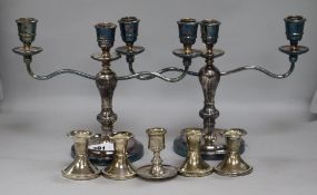 A pair of candelabra and five other dwarf candlesticks