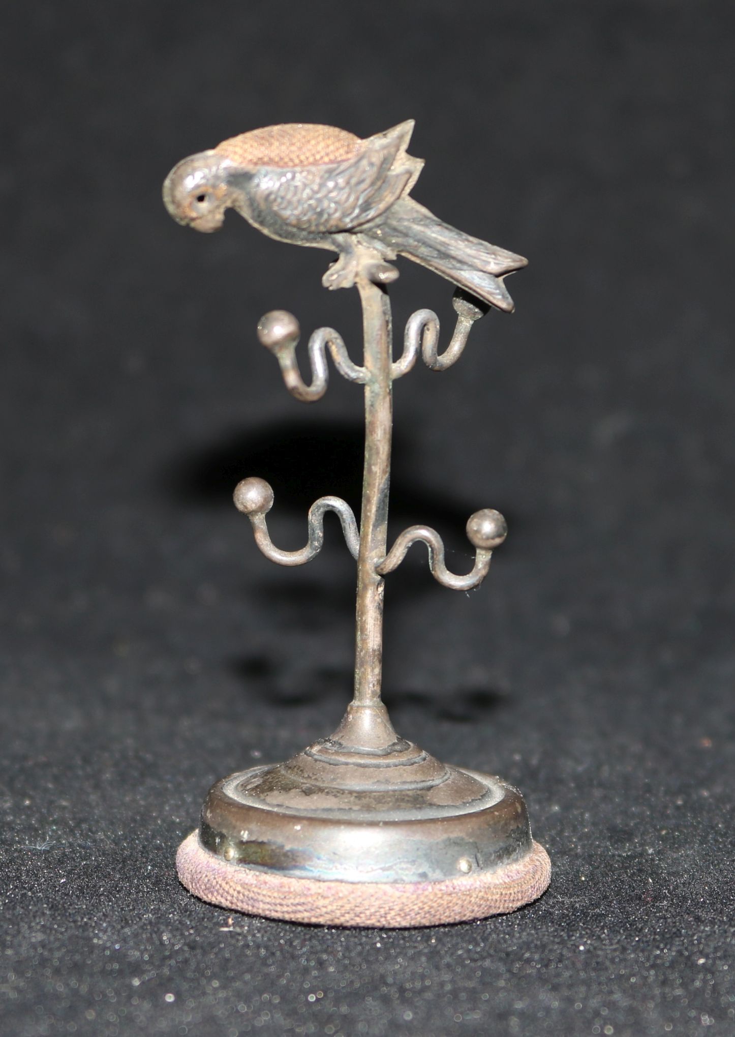 An Edwardian silver 'parrot perch' ring stand/pin cushion, by Adie & Lovekin, Birmingham, 1909,