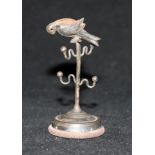 An Edwardian silver 'parrot perch' ring stand/pin cushion, by Adie & Lovekin, Birmingham, 1909,