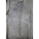 A large collection of embroidered sheets and pillow cases