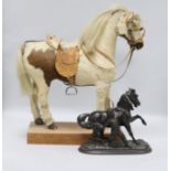 A model pony on wooden plinth with leather saddle and bridle and a spelter model of a horse with a
