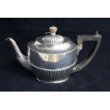 A late Victorian demi fluted silver oval teapot by Army & Navy, London, 1888, gross 16 oz.