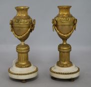 A pair of Louis XVI style ormolu candlesticks