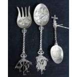 A Dutch embossed silver spoon with tavern scene bowl and galleon finial, a similar fork with