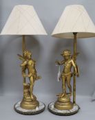 A pair of gilt cherub table lamps
