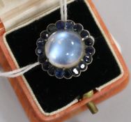 A white metal, moonstone and gem set dress ring, size M.
