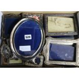 A collection of eleven silver photograph frames and one other frame.