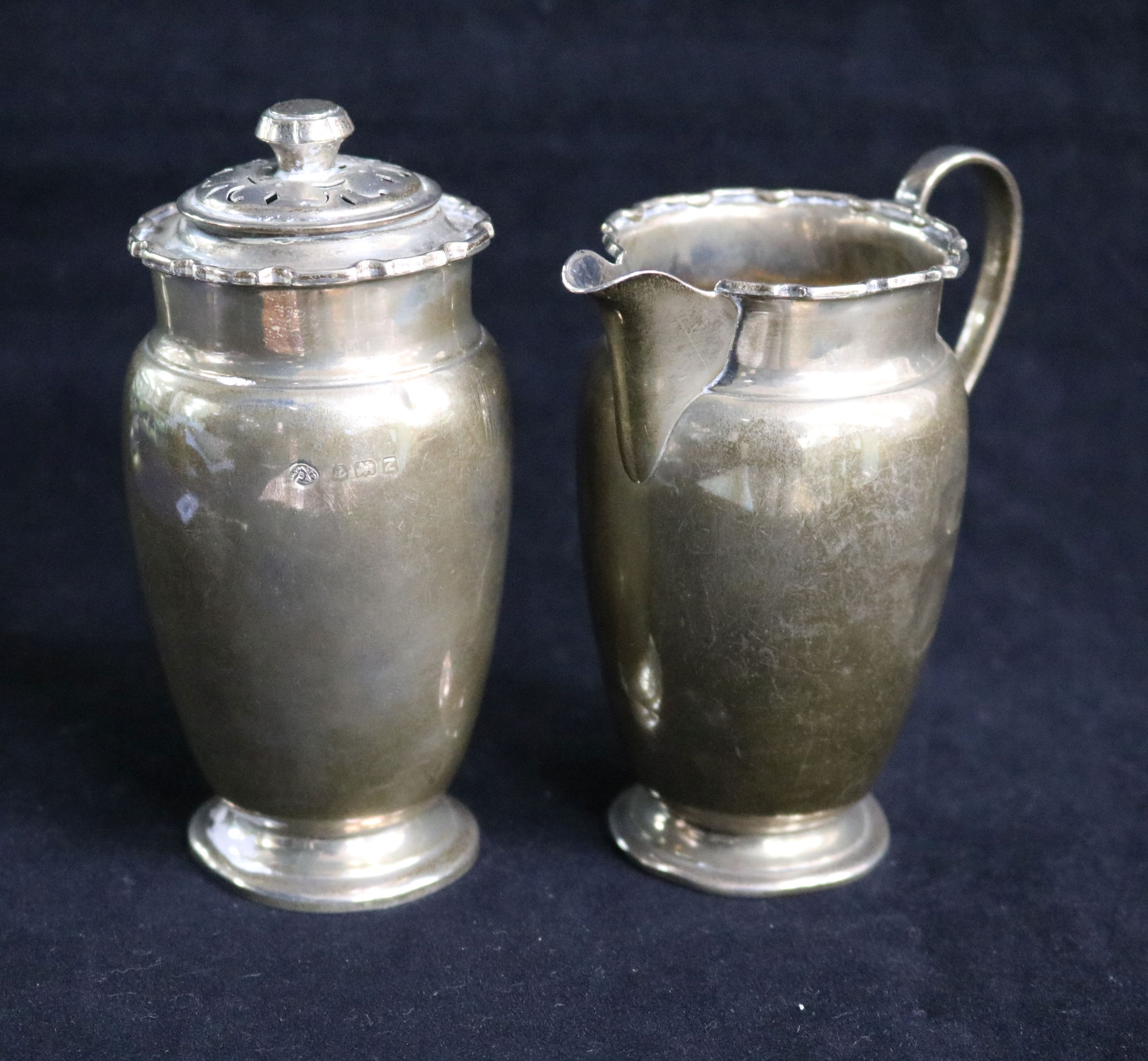 A late 1940's silver milk jug and a matching sugar shaker. 7 oz.