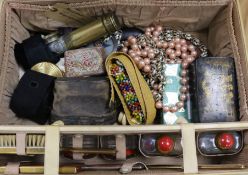 A suitcase with sundries including costume jewellery