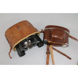 A pair of cased military binoculars and a camera