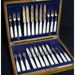 A 1930's cased set of twelve pairs of mother of pearl handled silver dessert eaters.