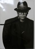 John Swannell, photograph of Elton John, signed and dated 1991, 50.5 x 41cm., unframed