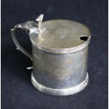 A 1920's silver drum shaped mustard pot with plated ladle.
