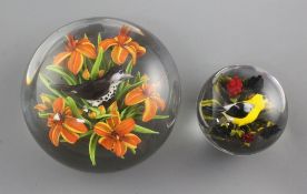 Two Rick Ayotte glass lampwork paperweights; a magnum Thrush in orange lilies, 2002, LE 25, 10cm and