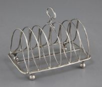 A George III silver seven bar toast rack by Thomas Lamborn, on ball feet, Sheffield, 1803?, 16.