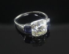 An impressive 1920's/1930's platinum and three stone diamond and sapphire ring, the central square