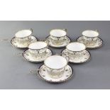 A set of six Royal Worcester porcelain tea cups and saucers, with silver cup holders and spoons,