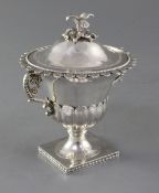 An early 19th century Italian silver two handled vase and cover, with bird finial and ornate