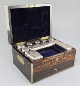 A Victorian brass mounted coromandel wood travelling toilet box containing ten silver mounted