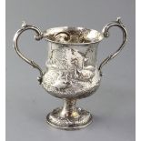 A Victorian silver two handled cup by Henry Holland, embossed with ducks and geese in a country