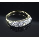 An 18ct gold and graduated five stone diamond half hoop ring, size T.