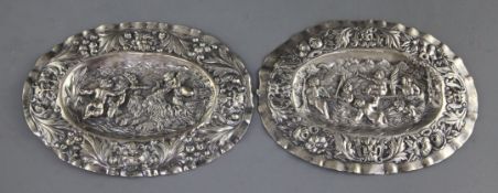 A pair of late 18th century Augsburg small silver oval plaques, embossed with cherubs, masks and