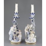 A pair of Meissen figural candlesticks, late 19th century, each modelled with a cherub and a
