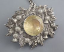 A 19th century Scottish white metal and citrine set cloak badge on chain, with thistle decoration,