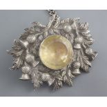 A 19th century Scottish white metal and citrine set cloak badge on chain, with thistle decoration,