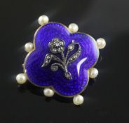 An Edwardian gold, blue enamel, rose cut diamond and seed pearl set pendant brooch, of quatrefoil